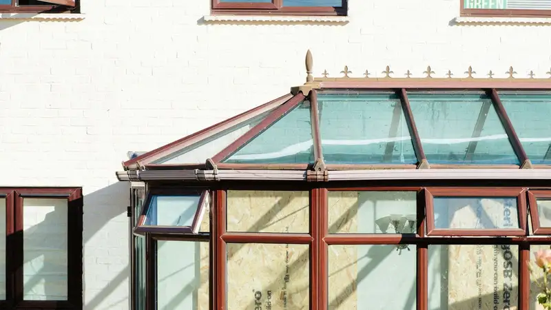 A glass conservatory roof on the back of a house