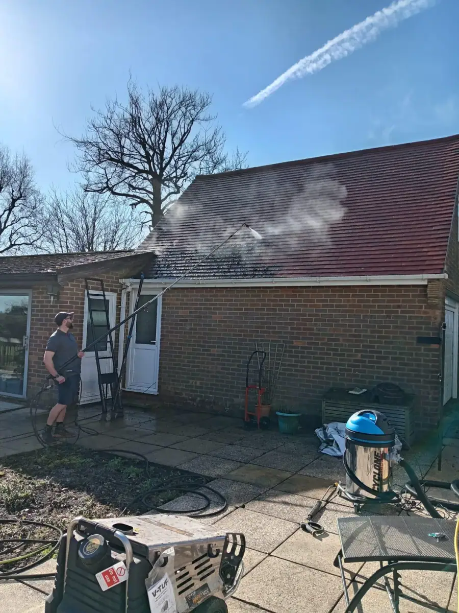 Visual Impact Roof Cleaning soft washing a tiled roof with a low-pressure extension lance